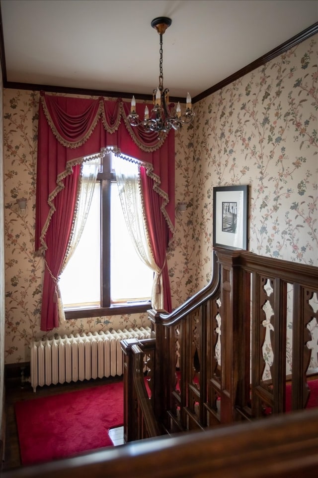 interior space with ornamental molding, a notable chandelier, and radiator