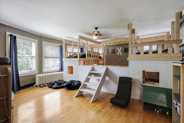 bedroom featuring hardwood / wood-style floors and radiator heating unit