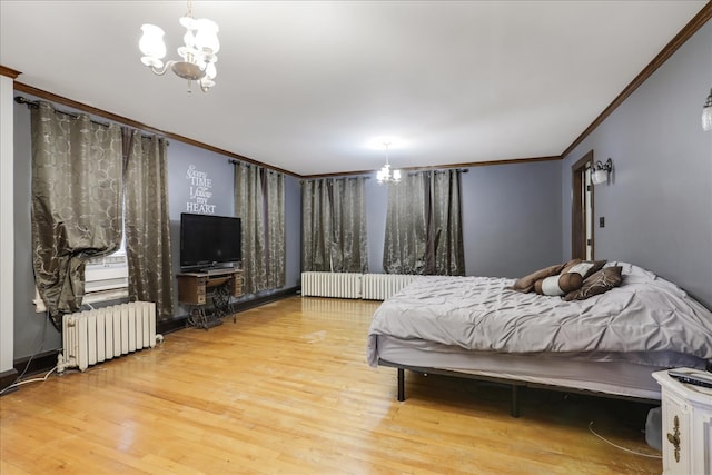 bedroom with hardwood / wood-style floors, crown molding, an inviting chandelier, and radiator