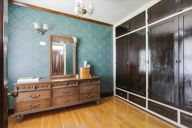 interior space featuring light hardwood / wood-style flooring, a closet, and crown molding