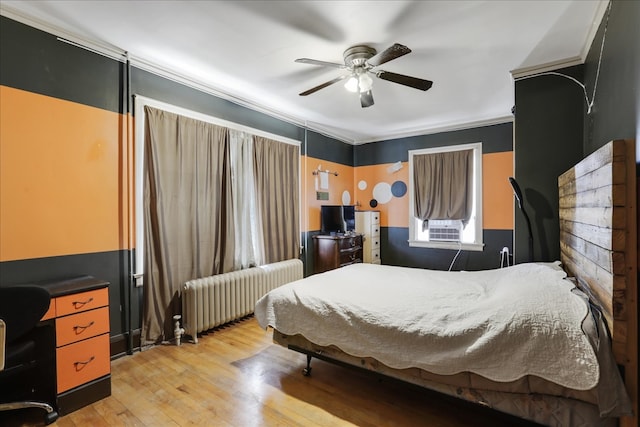 bedroom with crown molding, radiator heating unit, light wood-type flooring, and ceiling fan