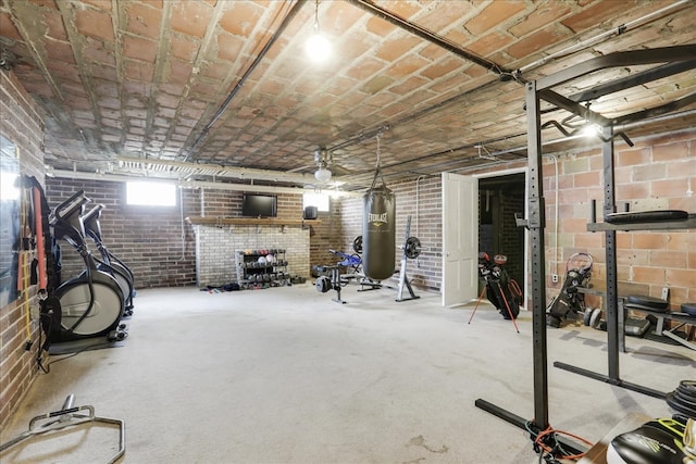 workout room featuring brick wall and brick ceiling