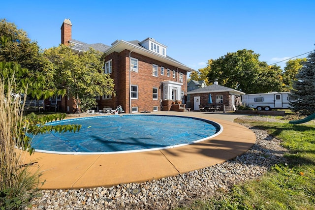 view of swimming pool with a patio