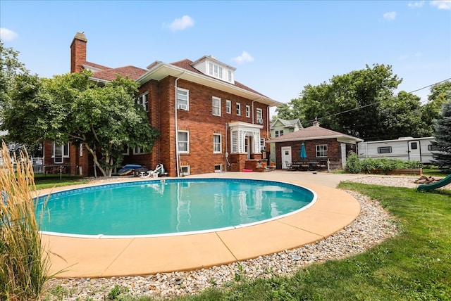 view of pool featuring a yard and a patio