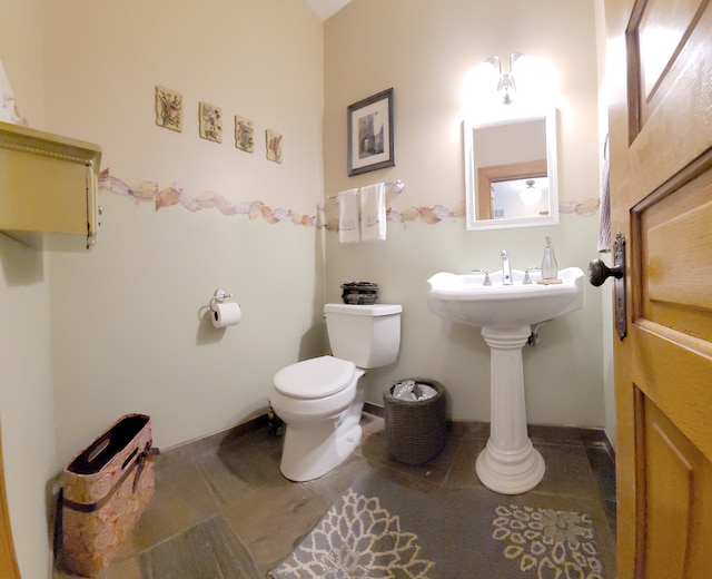 bathroom featuring tile floors and toilet