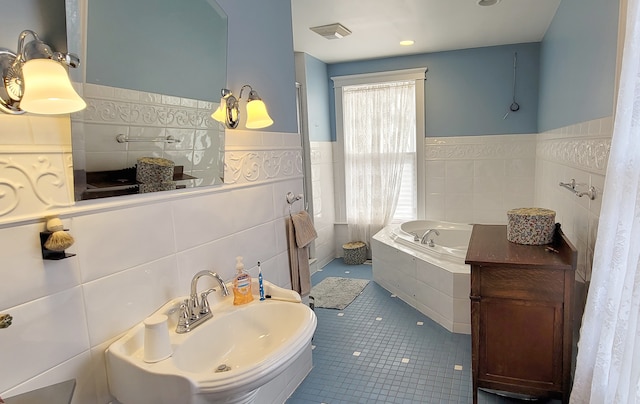 bathroom featuring tile walls, tiled tub, tasteful backsplash, and tile flooring