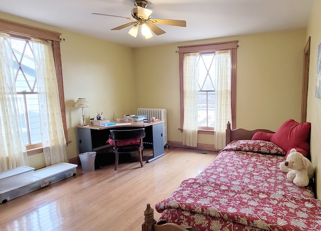 bedroom with ceiling fan and light hardwood / wood-style flooring