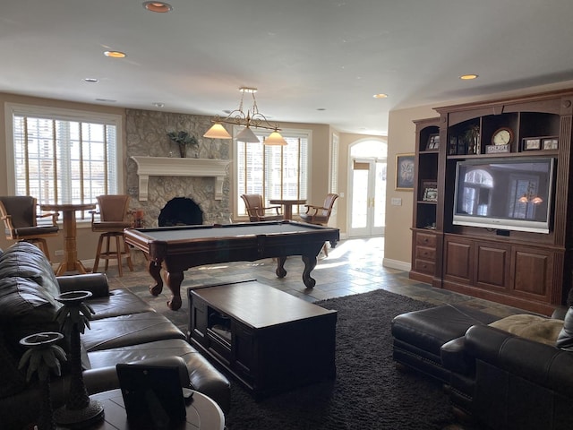 living room with billiards and a fireplace