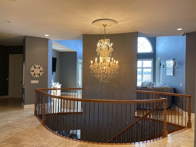 hallway featuring tile patterned floors and a chandelier