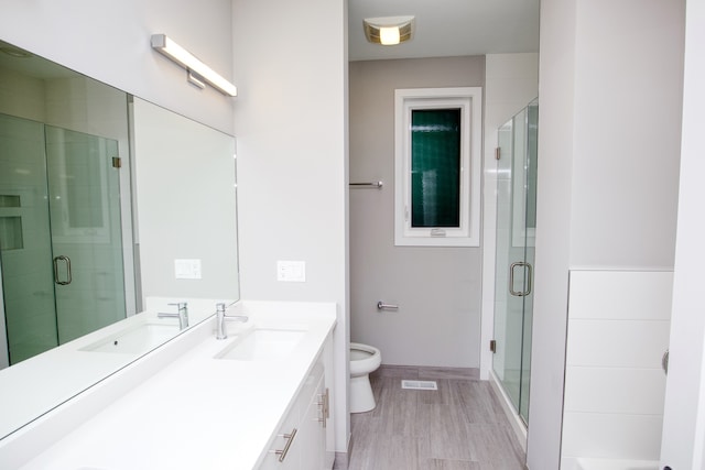 2520 S Stark St, Chicago, IL 60608 - bathroom with vanity, a shower with door, and toilet