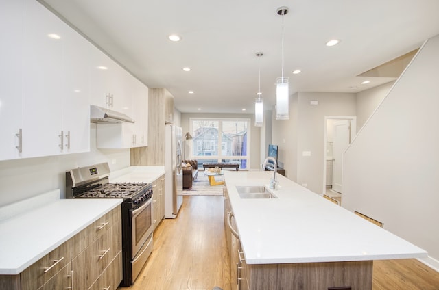 2520 S Stark St, Chicago, IL 60608 - kitchen featuring a center island with sink, appliances with stainless steel finishes, and sink