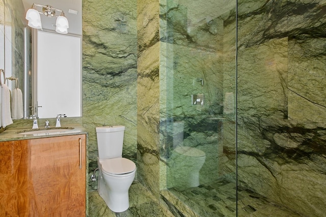 bathroom with an enclosed shower, vanity, and toilet