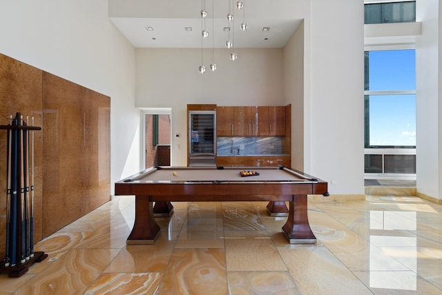 game room featuring a towering ceiling and billiards