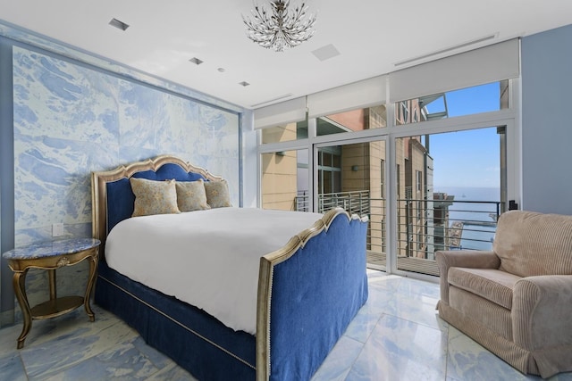 bedroom featuring a water view and access to exterior