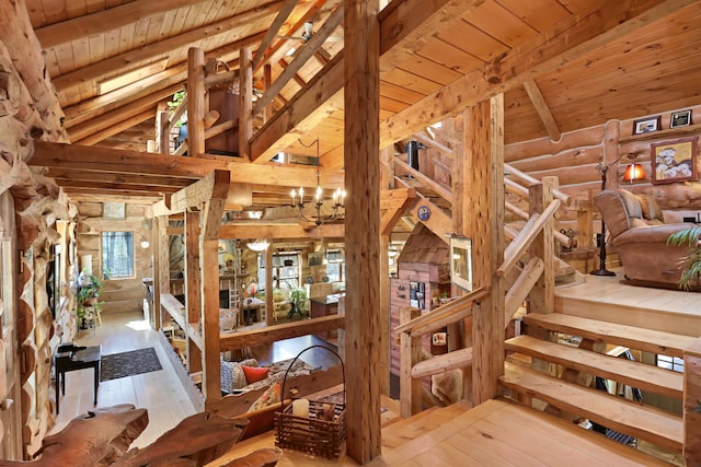 miscellaneous room with wood ceiling, vaulted ceiling with beams, a chandelier, and light hardwood / wood-style flooring