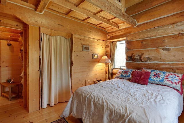 bedroom featuring wood ceiling, light hardwood / wood-style flooring, and beam ceiling