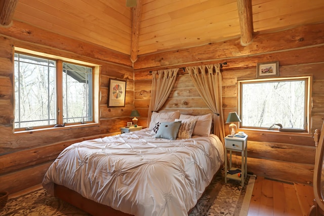 bedroom featuring dark hardwood / wood-style flooring, multiple windows, wooden ceiling, and rustic walls