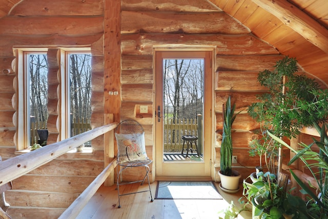 entryway featuring lofted ceiling, log walls, and wooden ceiling