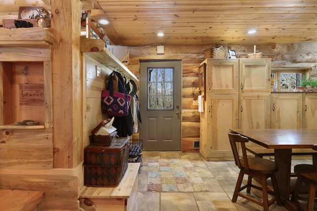 interior space with light tile flooring, wooden ceiling, and rustic walls