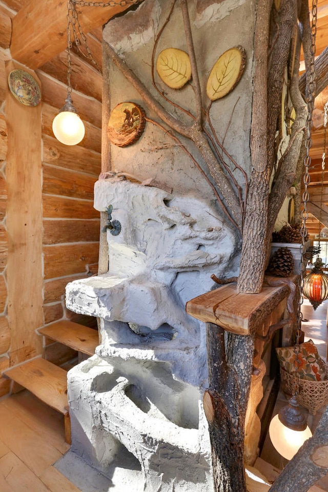 interior details featuring hardwood / wood-style floors and rustic walls