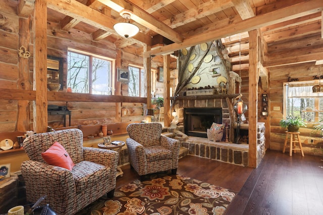 living area featuring beam ceiling, dark hardwood / wood-style flooring, a fireplace, and a healthy amount of sunlight