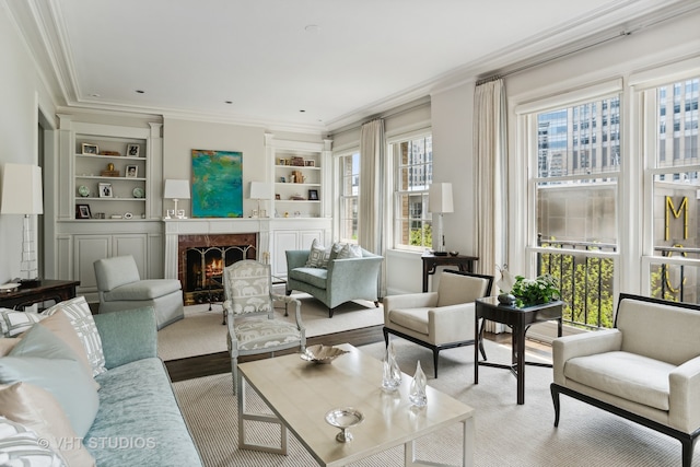 living room with ornamental molding, a wealth of natural light, and built in shelves