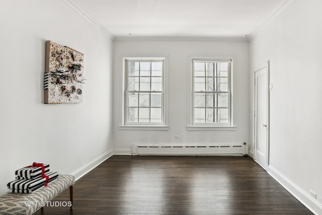 empty room featuring ornamental molding, dark hardwood / wood-style floors, and baseboard heating