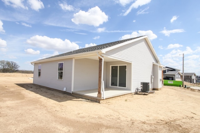 back of house with central air condition unit and a patio area