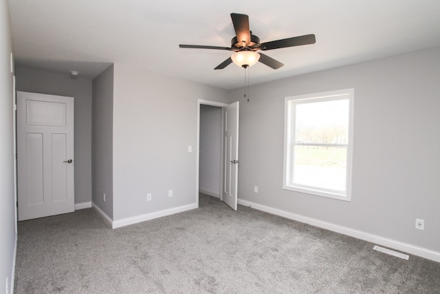 unfurnished bedroom with ceiling fan and light colored carpet