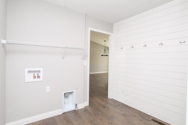 washroom with hookup for a washing machine and dark hardwood / wood-style flooring