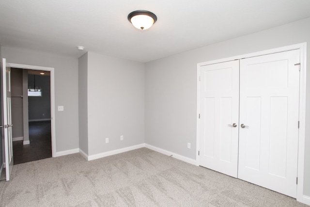 unfurnished bedroom with light carpet and a closet