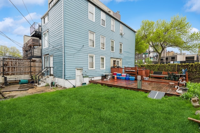 612 N Ogden Ave, Chicago, IL 60642 - rear view of house featuring a lawn, a balcony, and a deck