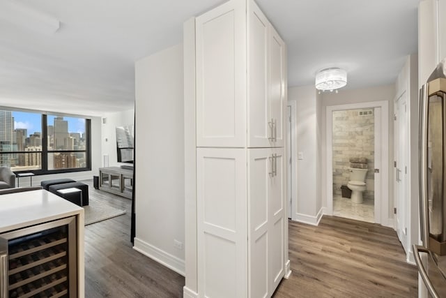 corridor featuring beverage cooler and dark wood-type flooring