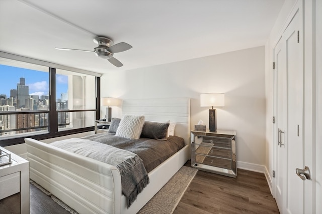 bedroom with ceiling fan and dark hardwood / wood-style floors