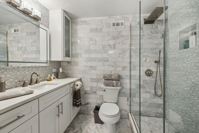 bathroom featuring tile walls, toilet, parquet flooring, an enclosed shower, and vanity