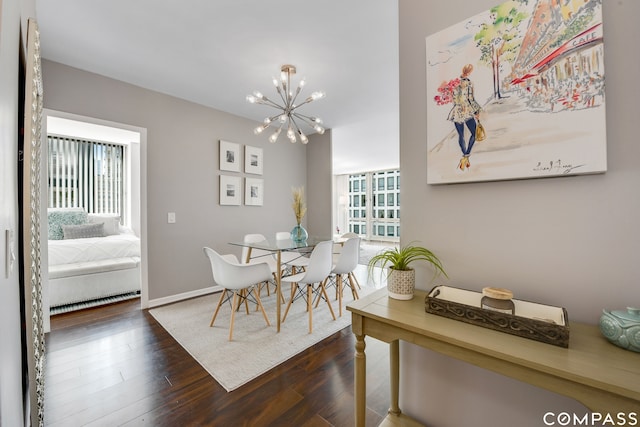 dining space with a wealth of natural light, dark wood-type flooring, and a chandelier