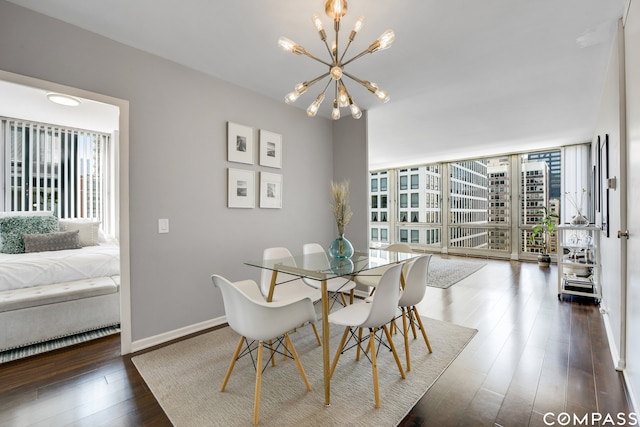 dining area with a notable chandelier and dark hardwood / wood-style floors