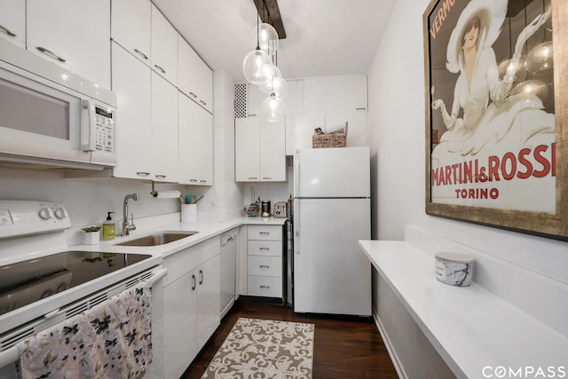 kitchen with white cabinets, white appliances, sink, and dark hardwood / wood-style flooring