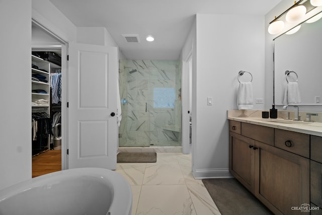 bathroom featuring vanity, tile flooring, and independent shower and bath