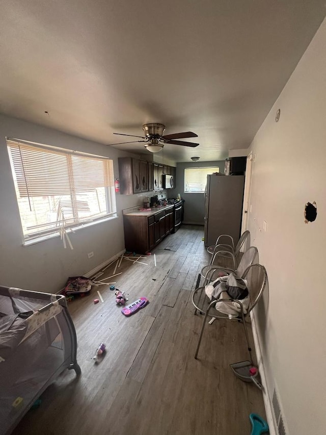 miscellaneous room with light wood-type flooring and ceiling fan