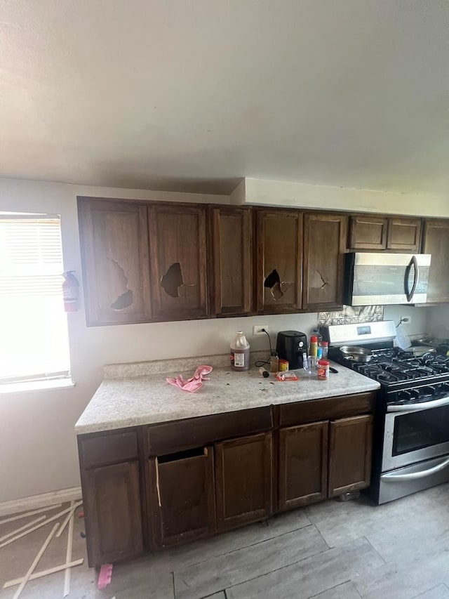 kitchen featuring dark brown cabinets and stainless steel appliances