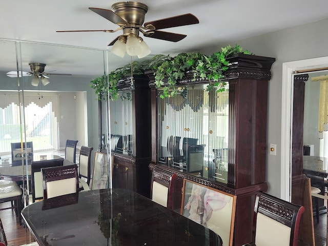 dining area with ceiling fan and dark hardwood / wood-style floors