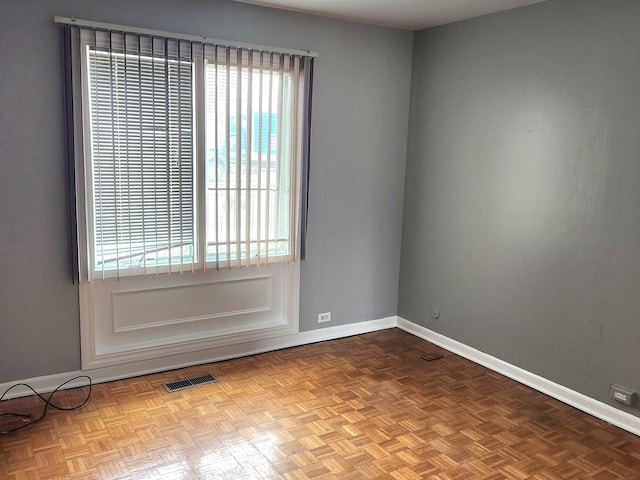 unfurnished room featuring light parquet floors