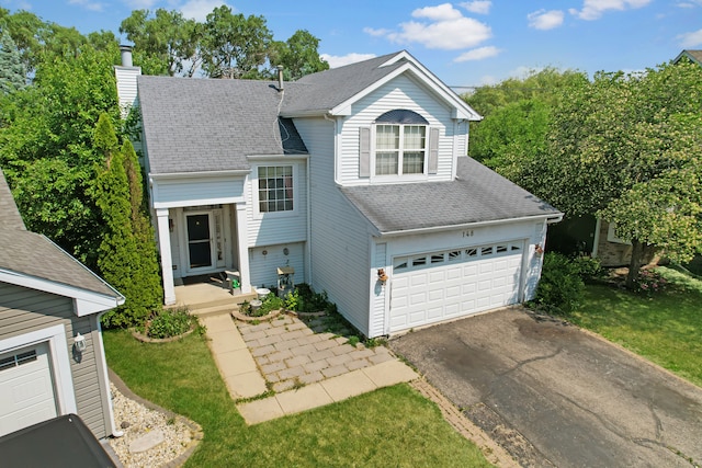 front facade featuring a front lawn and a garage