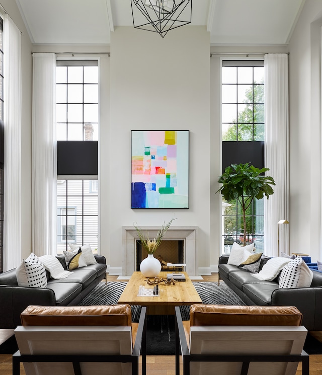 living room featuring crown molding, a high ceiling, and hardwood / wood-style flooring