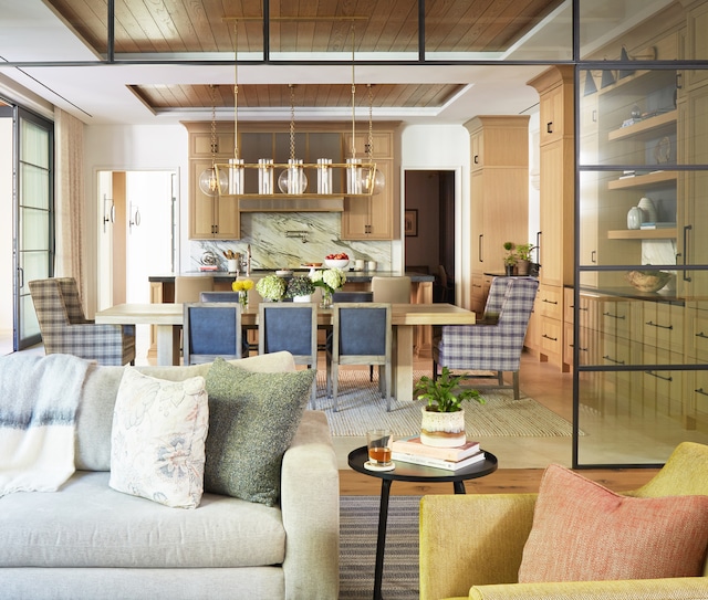 living room featuring wooden ceiling, wood-type flooring, and an inviting chandelier