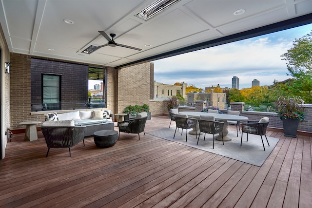 wooden deck with an outdoor hangout area and ceiling fan