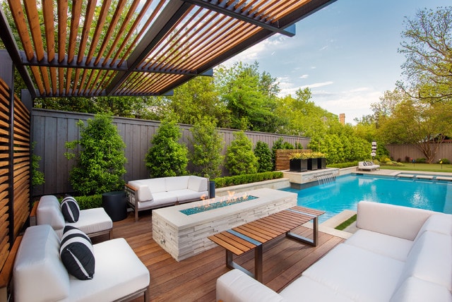 view of swimming pool with a pergola, an outdoor living space with a fire pit, and pool water feature