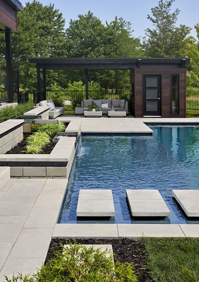 view of swimming pool with outdoor lounge area, a patio area, and pool water feature