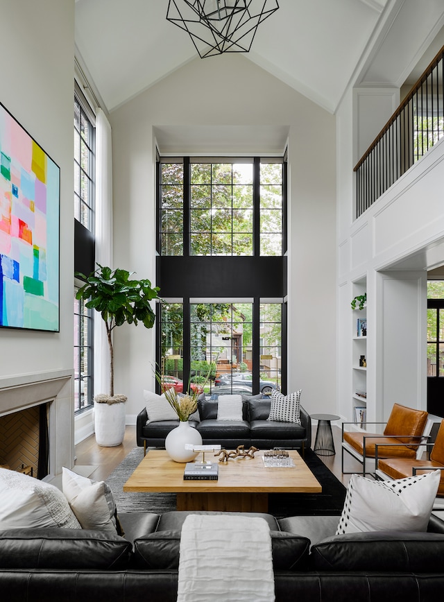 living room featuring high vaulted ceiling, hardwood / wood-style floors, and plenty of natural light